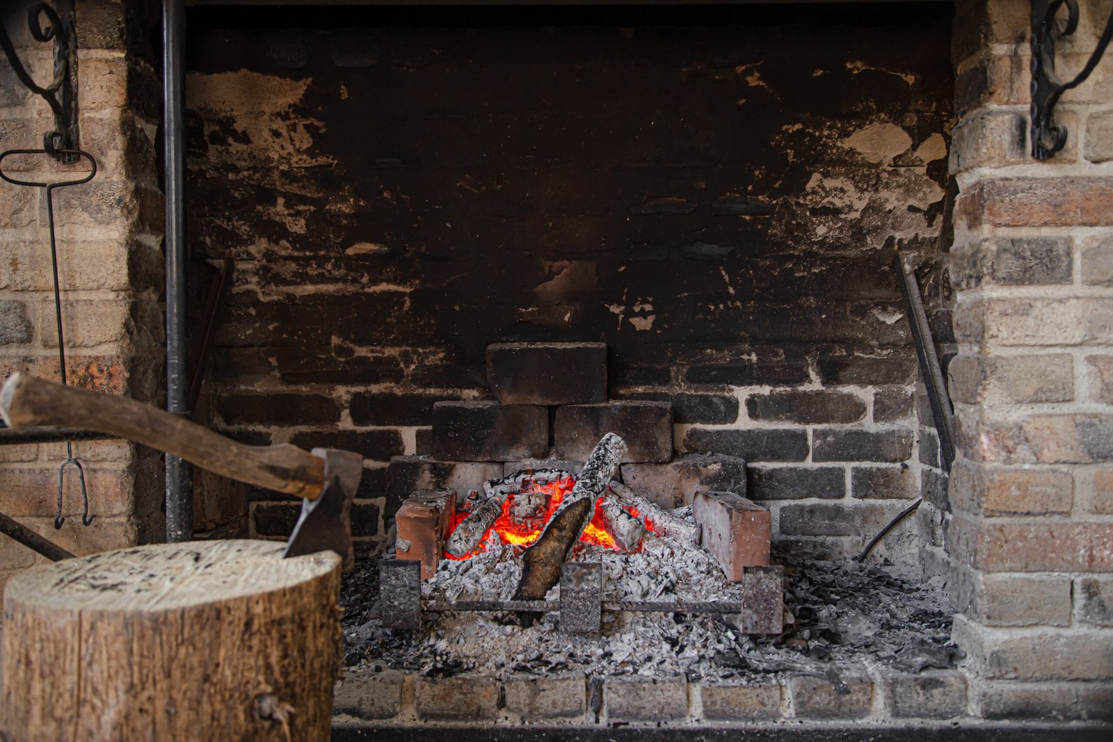 Large Fireplace with a burning fire and decorative items, comfort and atmosphere.